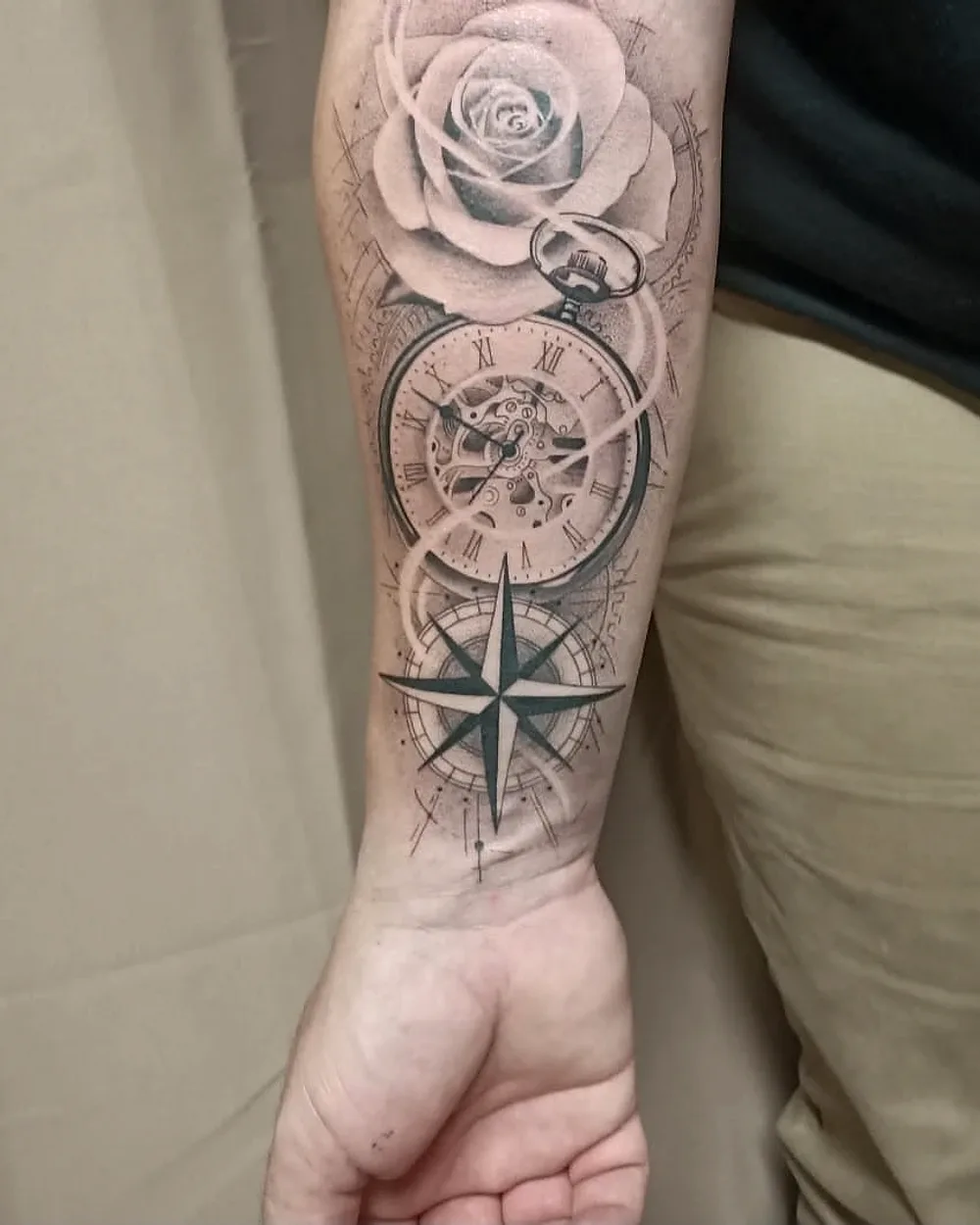 Tatouage rose, montre à gousset et boussole sur l'avant-bras, réalisme noir et gris, ProSkin-R Cahors